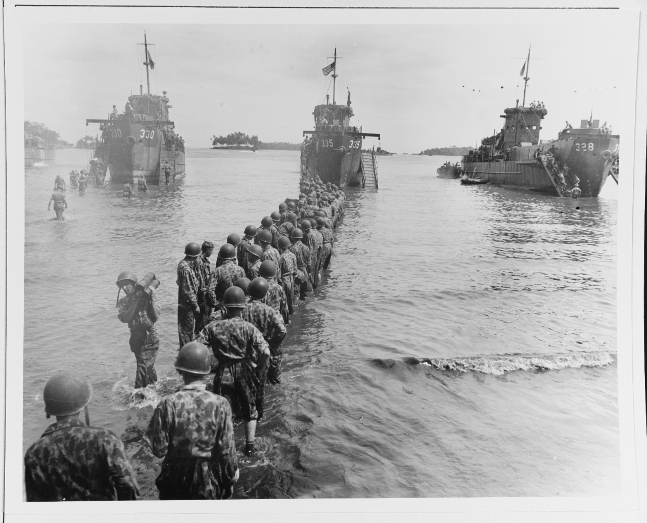 Troops unloading ammunition from LCI-330, 335, and 328 during landing operations at Rendova Island, 30 June 1943.